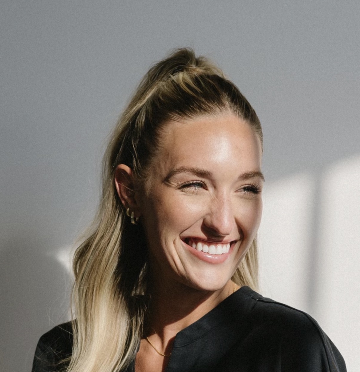 Lauren smiling in natural light